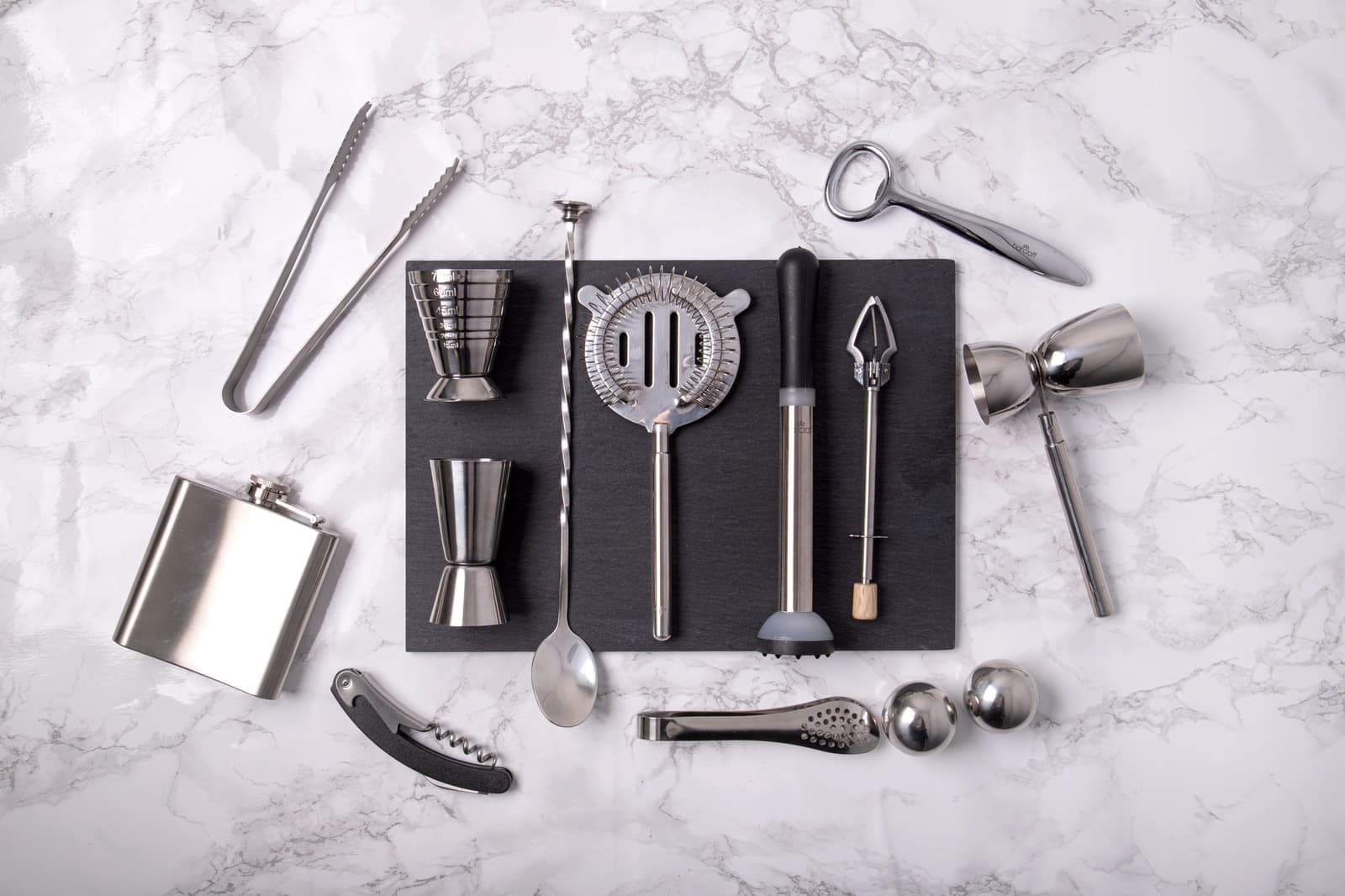 Close detail of stainless steel bar tools on a dark surface