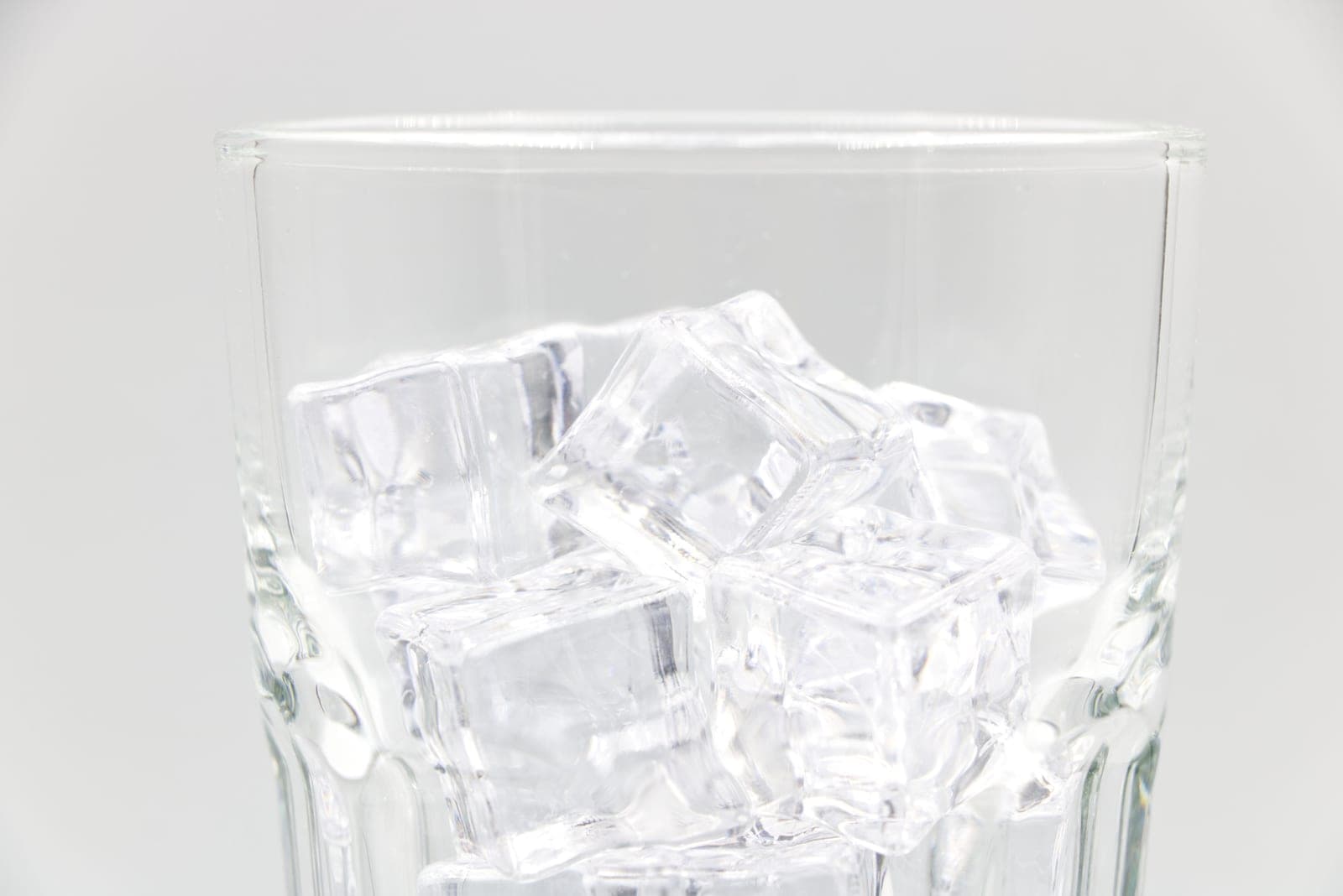 Large clear ice cubes stacked on a dark surface
