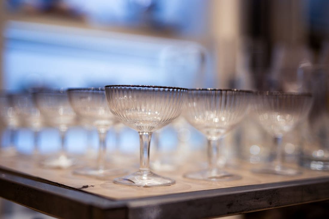 A stemmed coupe glass holding a clear cocktail