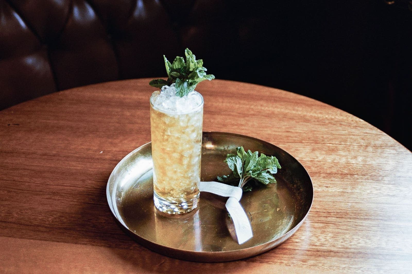 A cold herb-garnished drink served over crushed ice