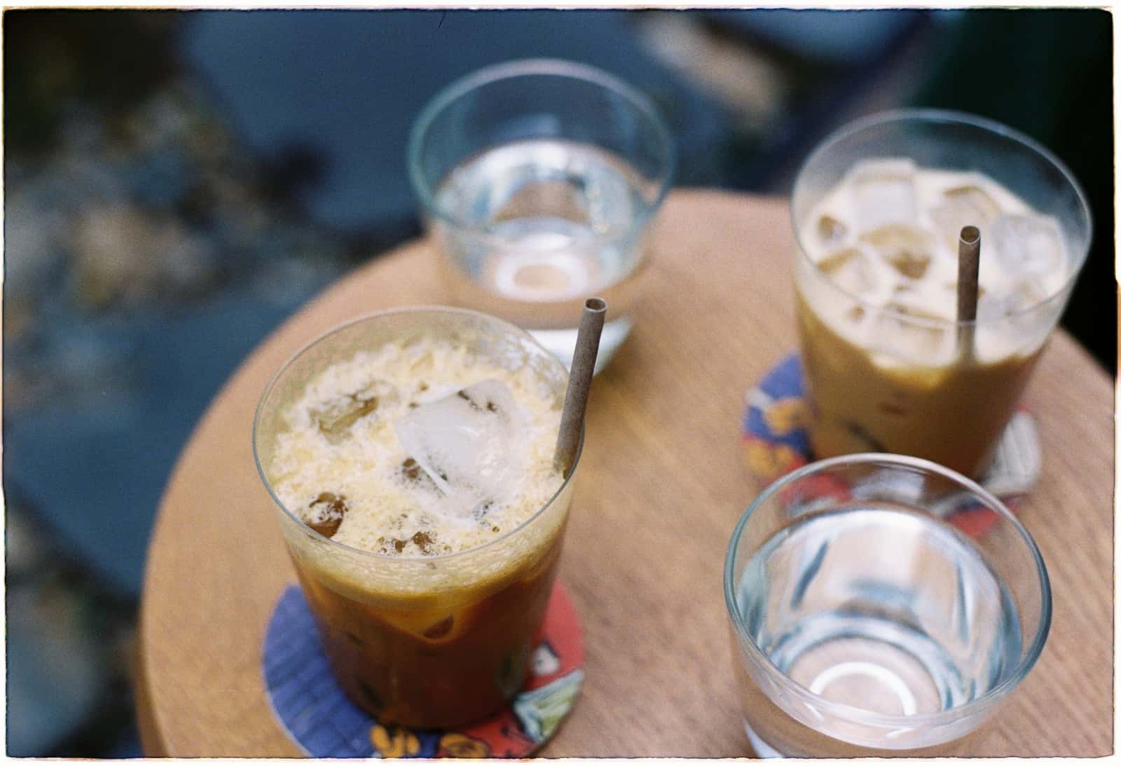 Clear ice cubes filling a tumbler under warm light