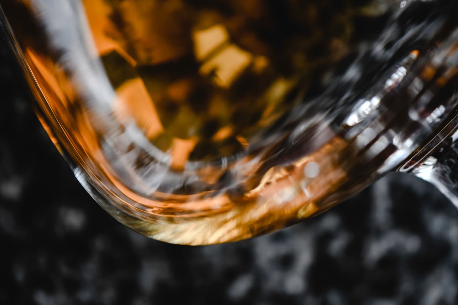 A tulip-shaped nosing glass holding a small whisky pour