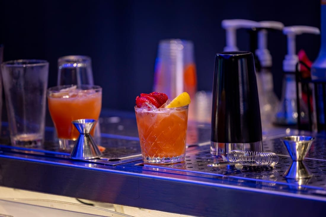 A finished cocktail with a garnish on a modern bar counter