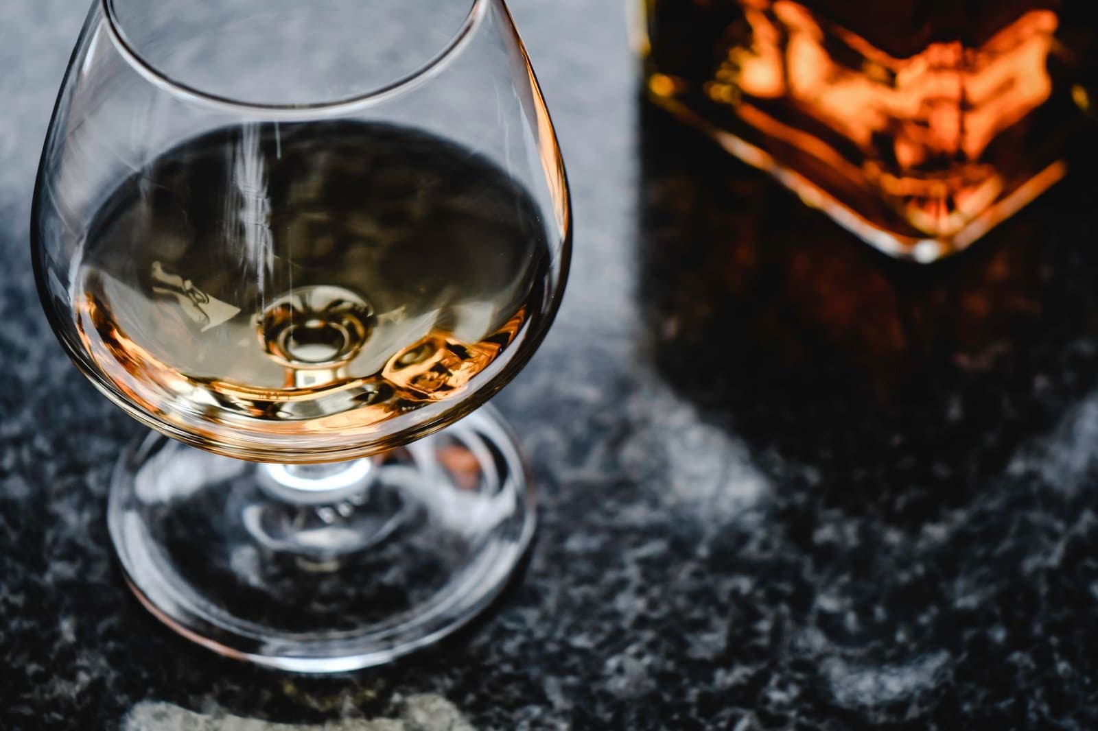 Cognac in a snifter glass on a marble surface
