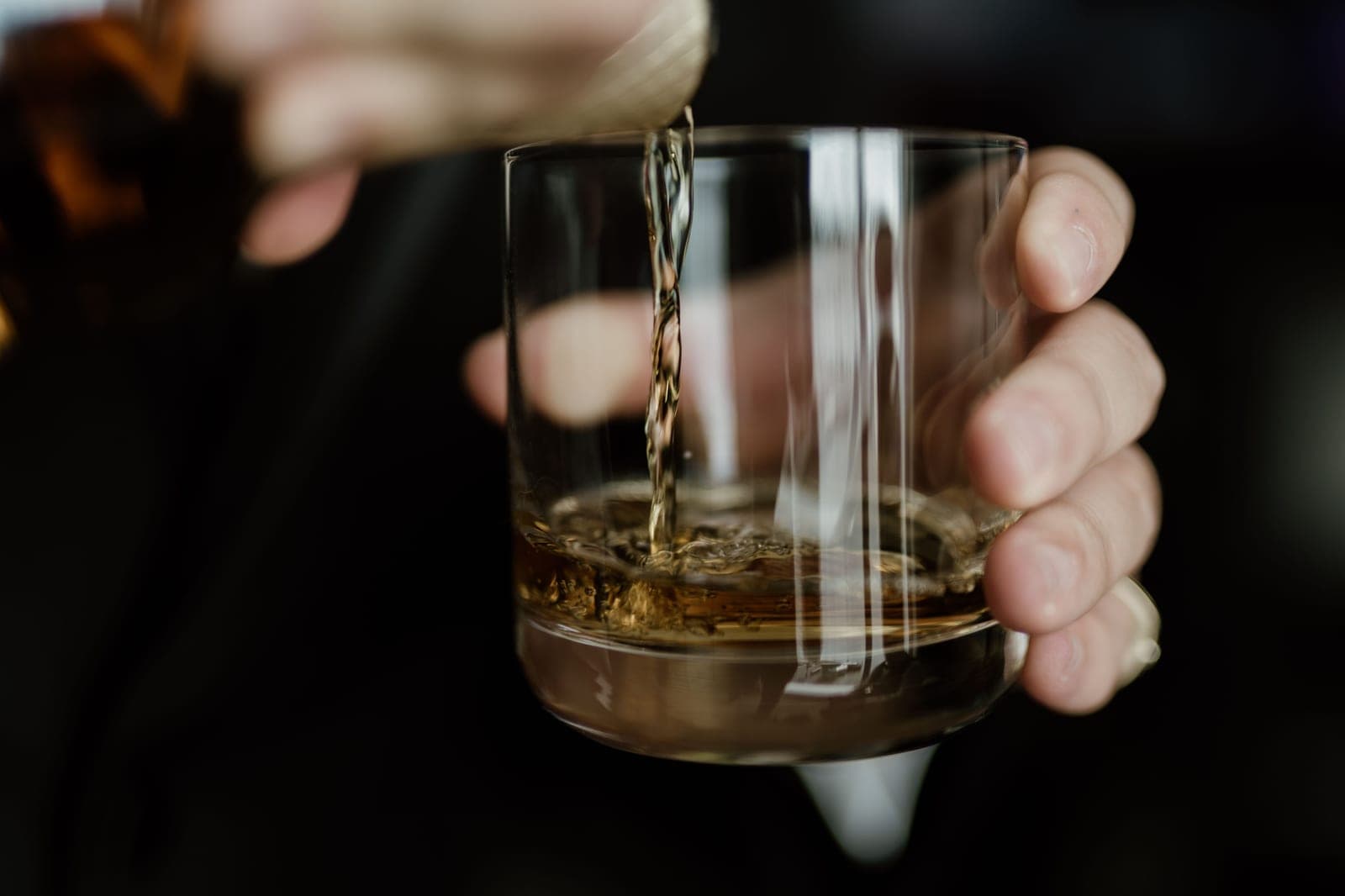 A double-walled whisky glass with an amber pour